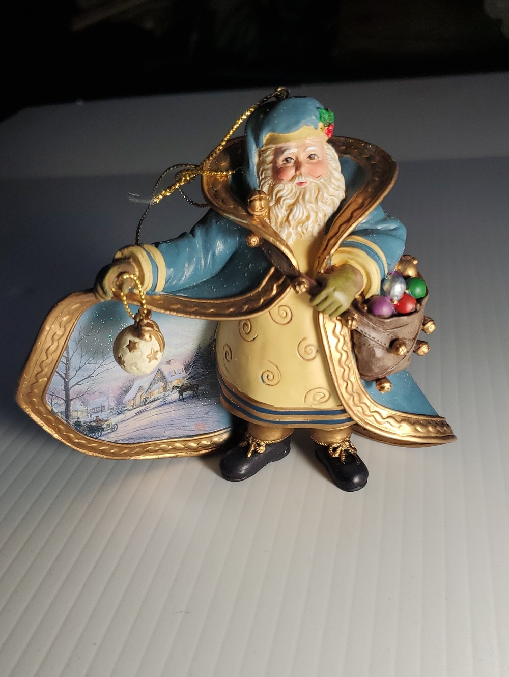 Thomas Kinkade Blue and Cream Santa Ornament with Gold Trim 1